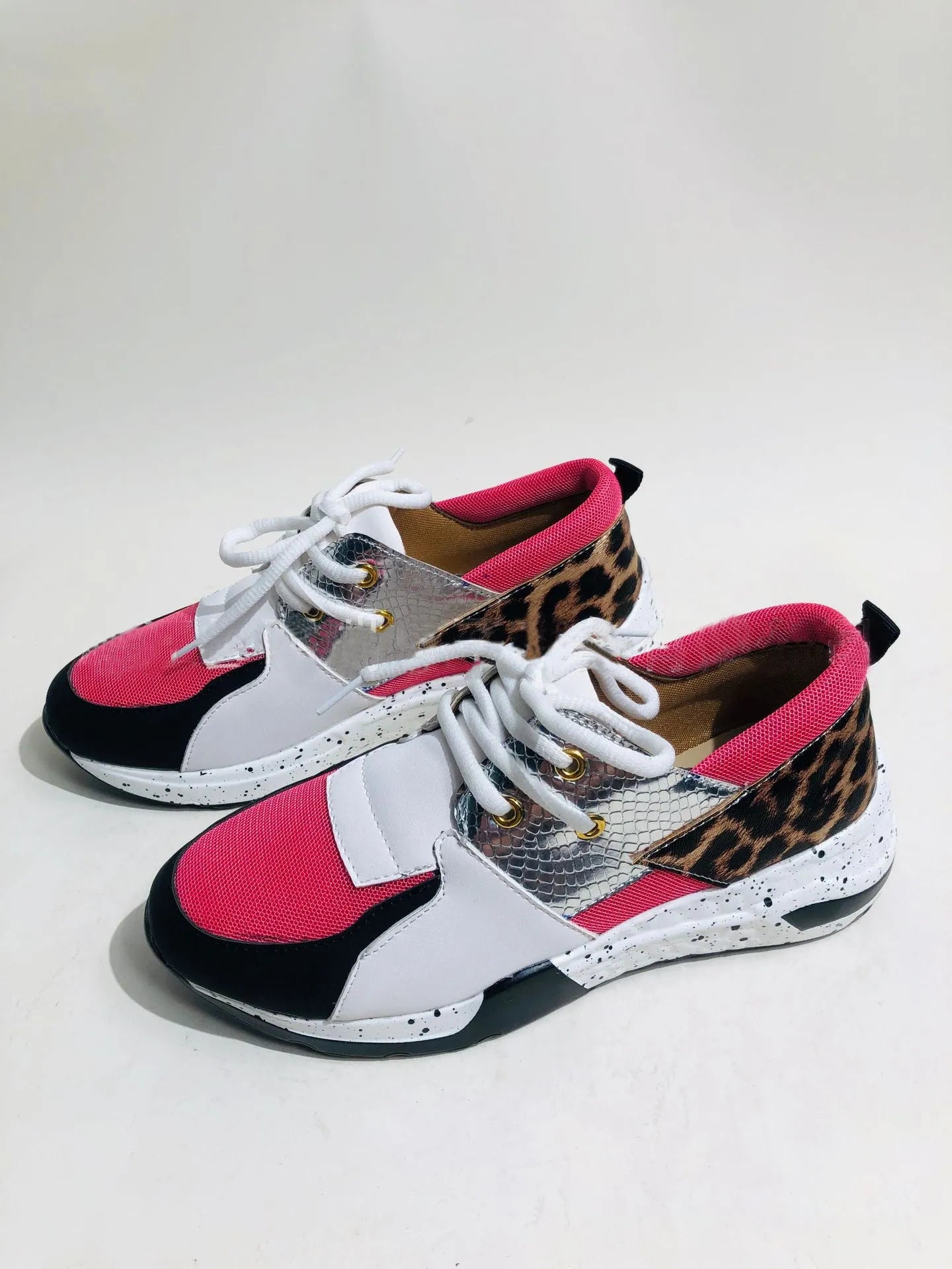 Women's black suede casual sneakers with a wedge heel on a white background