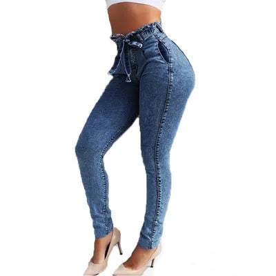 Women's fringed jeans in cowboy denim fabric showing decorative leg fringing detail
