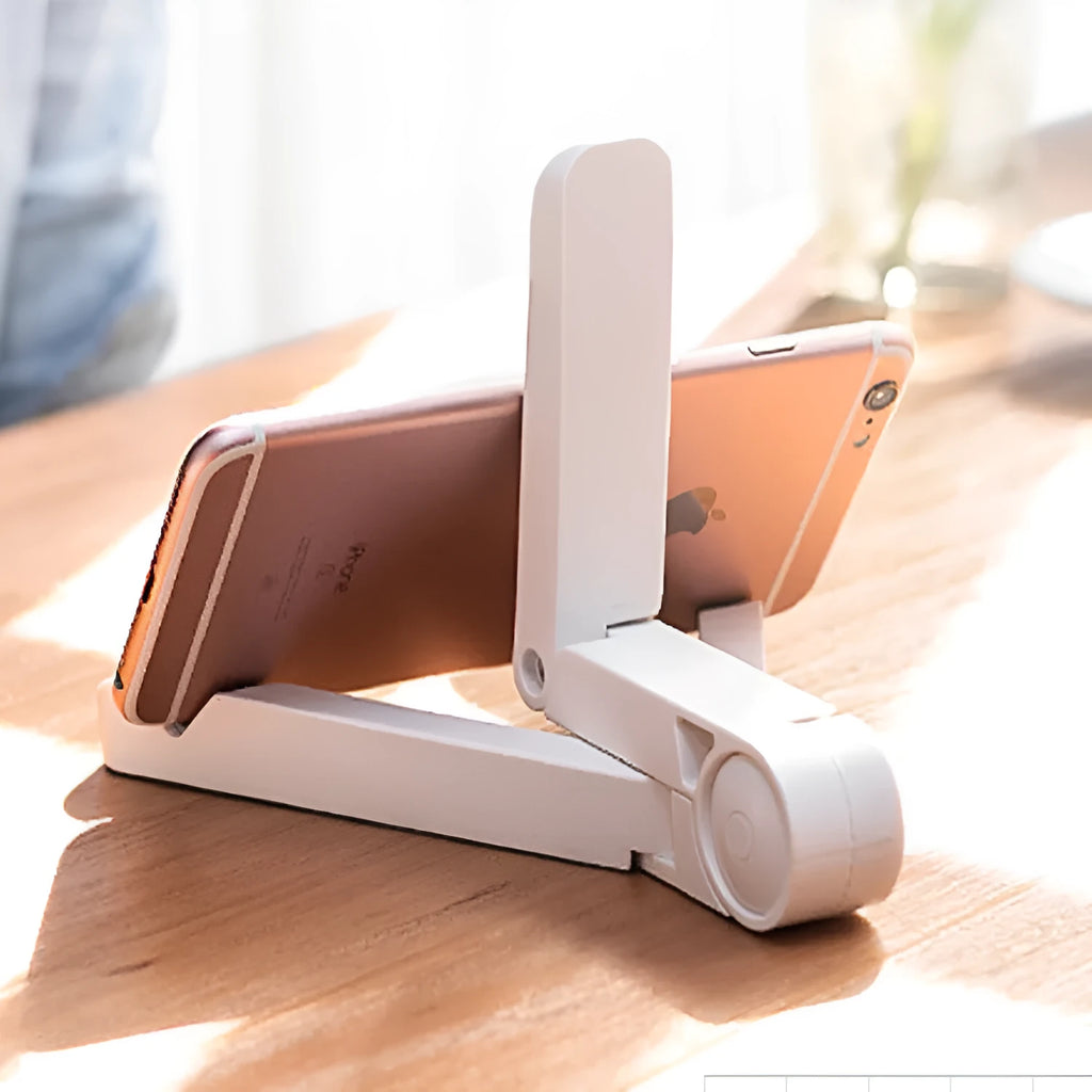 Black foldable tablet holder standing upright with a tablet device resting on its non-slip rubber surface.