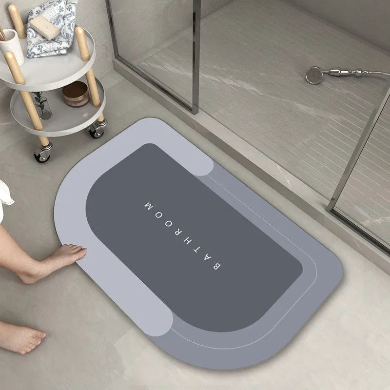 Blended fabric bathroom floor mat in oval and rectangular shapes on a tiled floor.