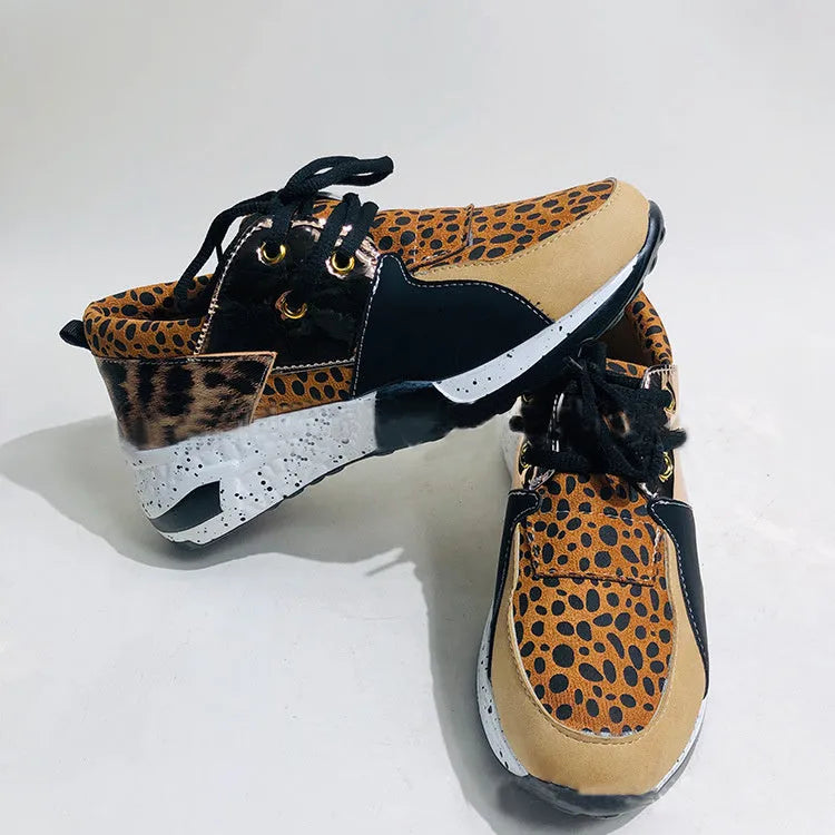 Women's black suede casual sneakers with a wedge heel on a white background