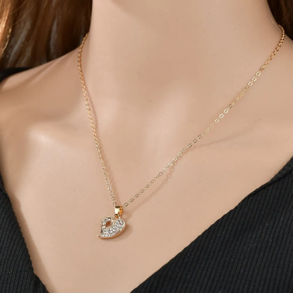 Gold-tone women's jewellery set with adjustable necklace, earrings, and hand decoration featuring love heart pendant