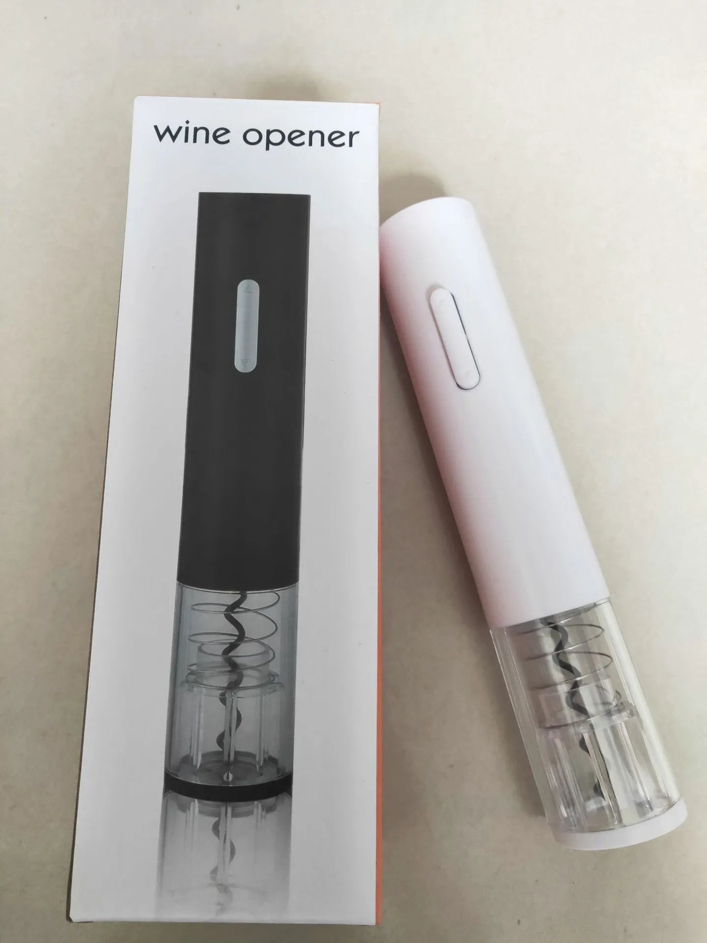 Black automatic electric wine bottle opener with foil cutter on a wooden table