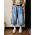 Men's loose straight-cut denim shorts in blue, shown on a hanger.