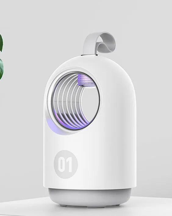 White indoor mosquito killer lamp with blue UV light and a top carry handle on a table