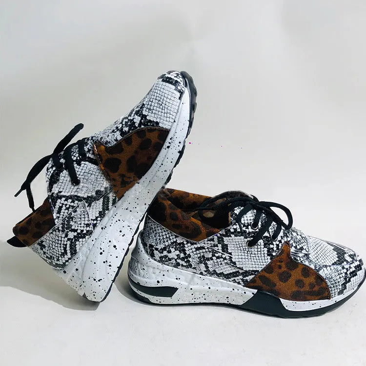 Women's black suede casual sneakers with a wedge heel on a white background