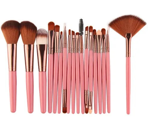 MAANGE 18-piece makeup brush set with fan-shaped cosmetic tools laid out on a table.