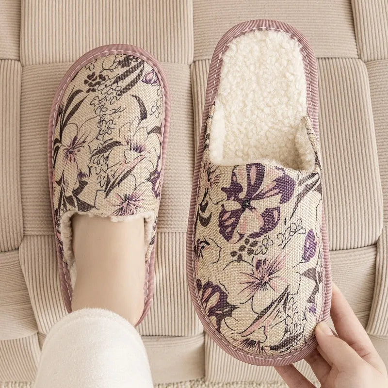 A pair of linen surface cotton lined slippers with a PVC sole, shown in a floral print colour option.