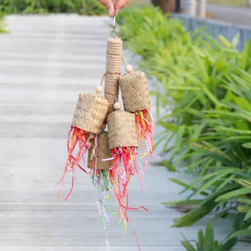Wood and sisal parrot toy with colourful shredded paper filling, size 15 by 35 centimetres