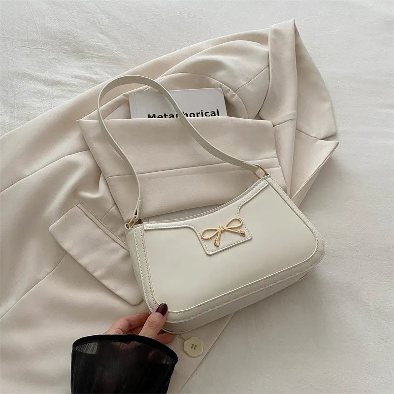 Western style baguette shoulder bag with bow detail showing horizontal square shape