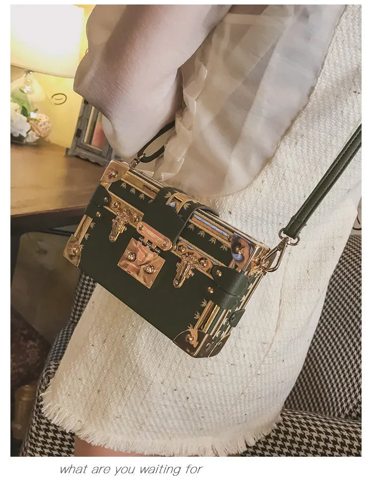 Women's structured shoulder bag with flap closure and adjustable crossbody strap in black or green