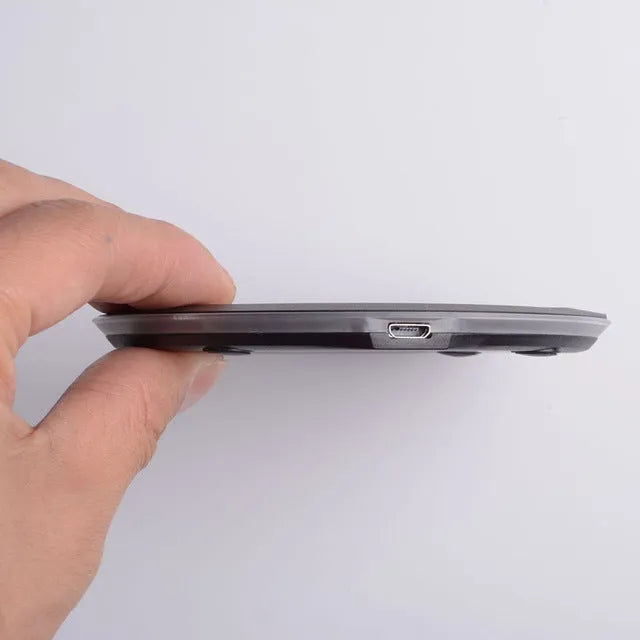 Ultra-thin wireless charger pad in black with LED indicator light and USB cable