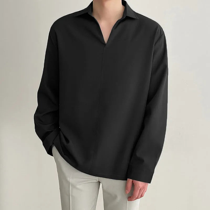 Man wearing a loose fit, solid colour, long sleeve casual shirt suitable for business.