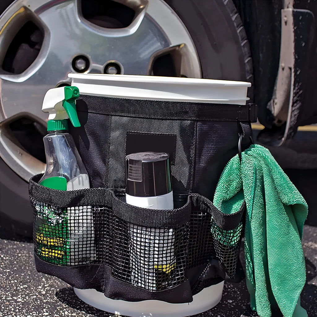 Black cylindrical polyester storage bag hanging from 5 gallon barrel for tool organisation