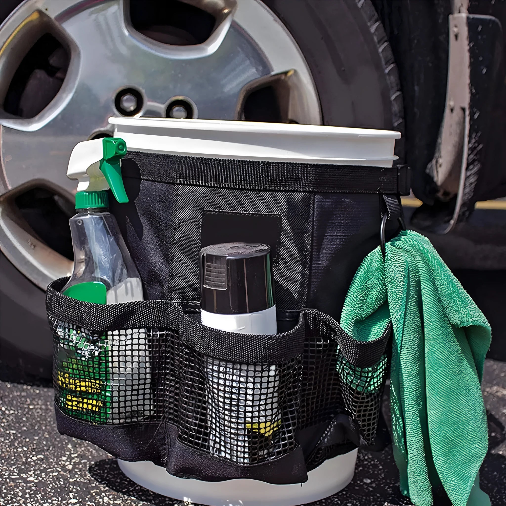 Black cylindrical polyester storage bag hanging from 5 gallon barrel for tool organisation