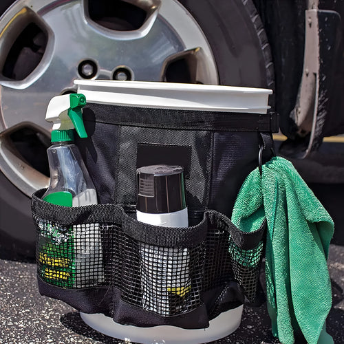 Black cylindrical polyester storage bag hanging from 5 gallon barrel for tool organisation