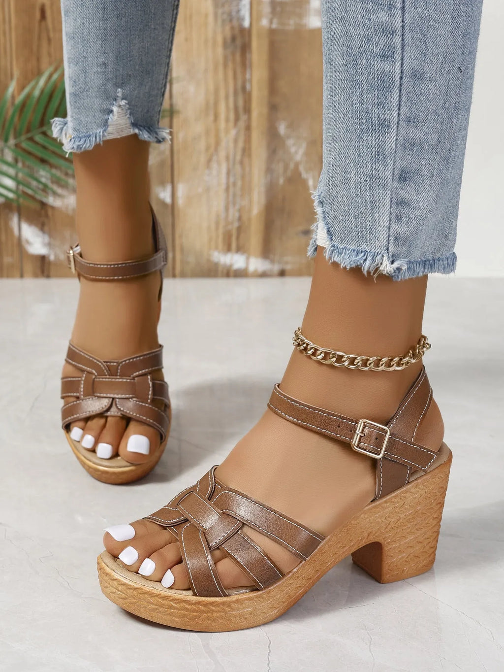 Plus size black women's sandals with peep toe, chunky heel, and ankle buckle strap on a white background.