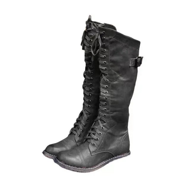 Women's black chunky heel high leg boots with a round toe on a plain background.