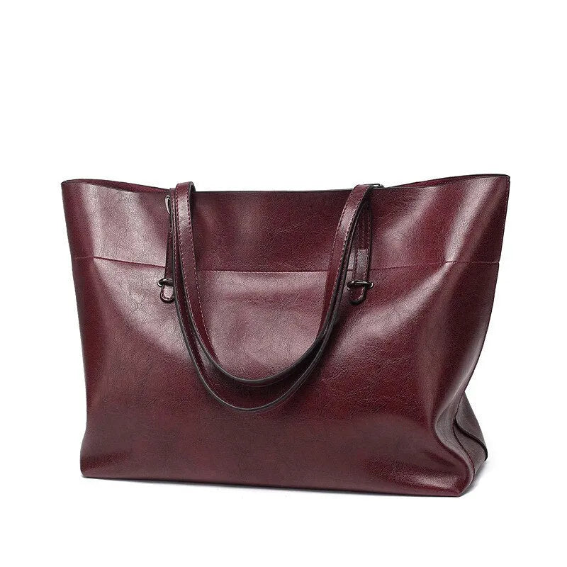 Brown waxed cowhide leather crossbody handbag showing two compartments and phone pocket