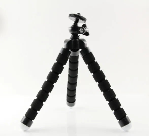 Black flexible octopus tripod with bent legs wrapped around a pole, holding a smartphone.