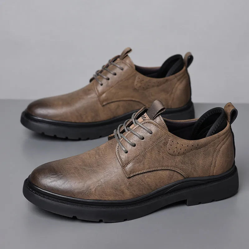 Men's black and brown leather casual sneakers with rubber sole and sewing line detail on the upper.