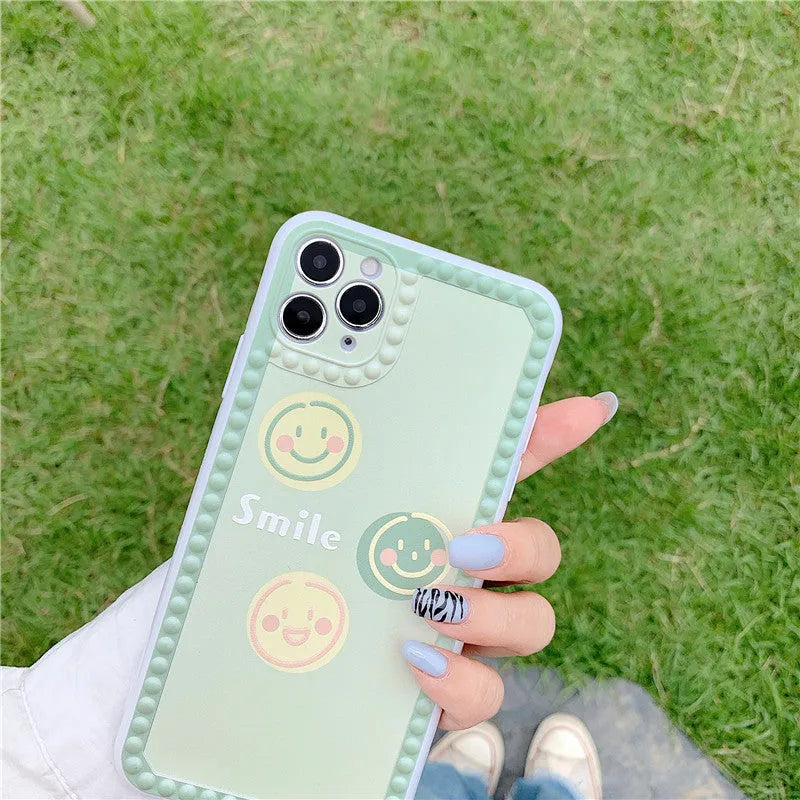 Green TPU iPhone case with polka dot frame and colourful smiley face geometry patterns