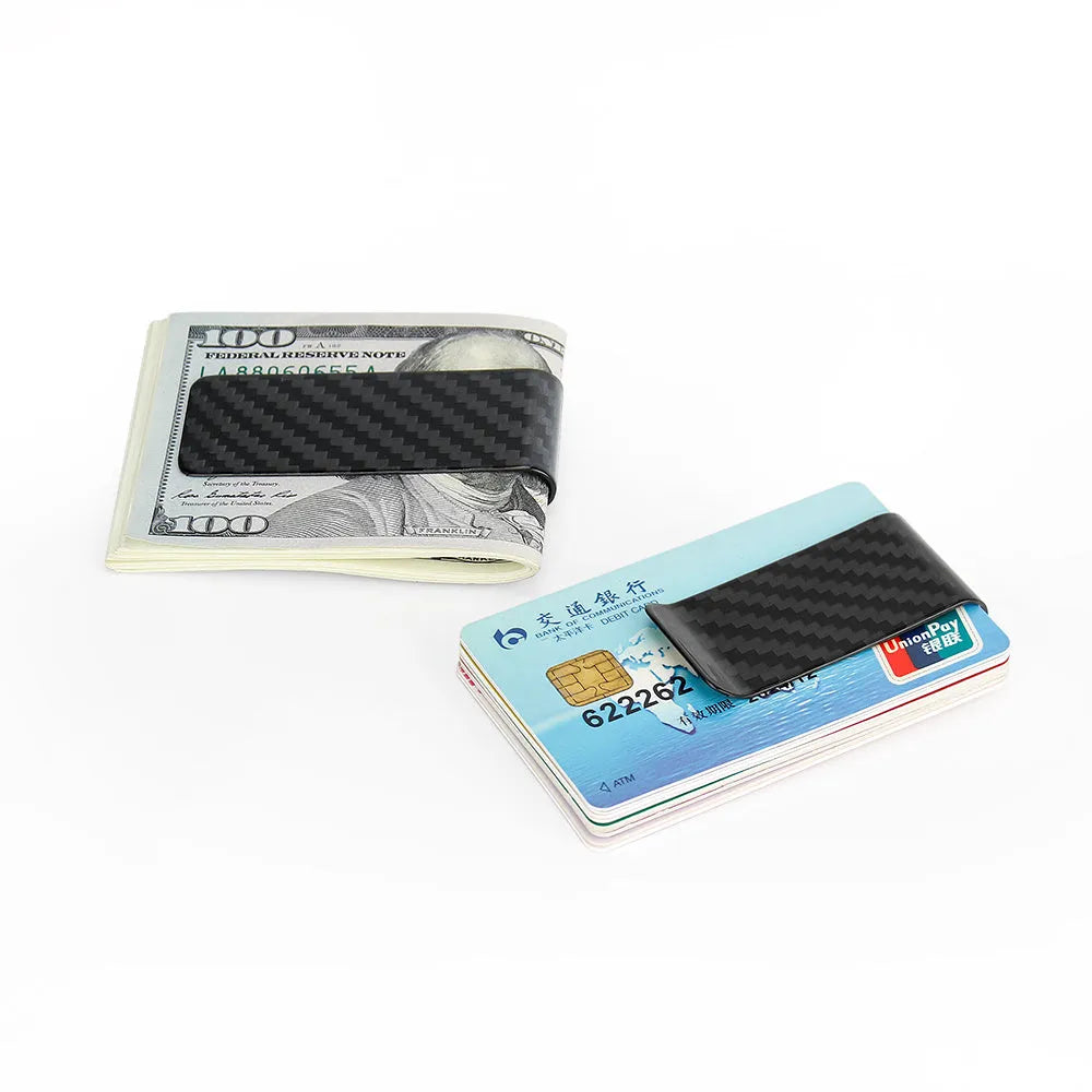 Black genuine carbon fiber money clip with striped glossy surface on a plain background