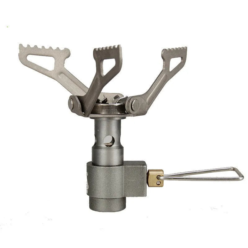 A portable single-burner propane camping stove with a one-piece metal furnace, shown outdoors.