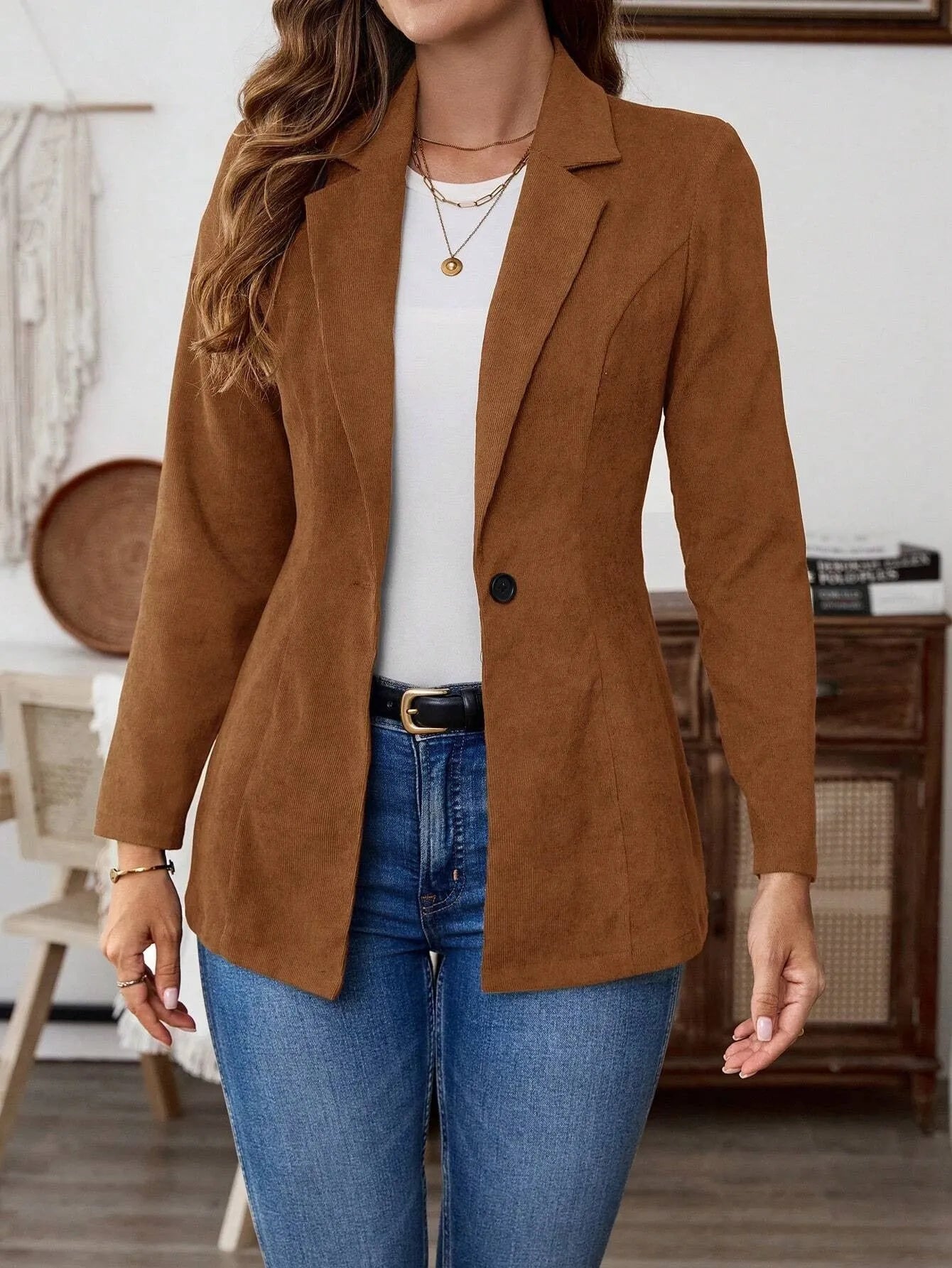 Brown single-breasted leisure suit coat with lapel collar and long sleeves on hanger
