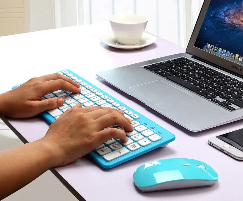 Black wireless keyboard and mouse set with 96 keys and a small USB receiver on a desk.