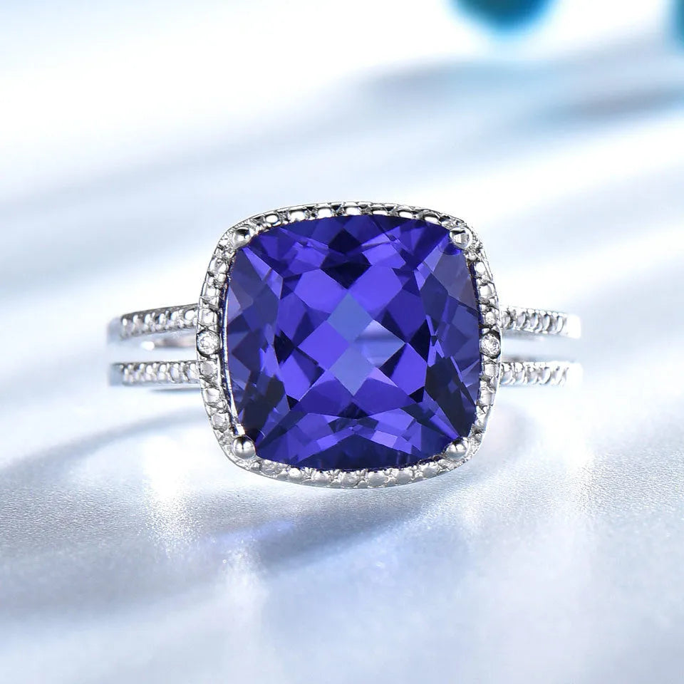 Women's sterling silver ring with a blue tanzanite gemstone on a polished band.