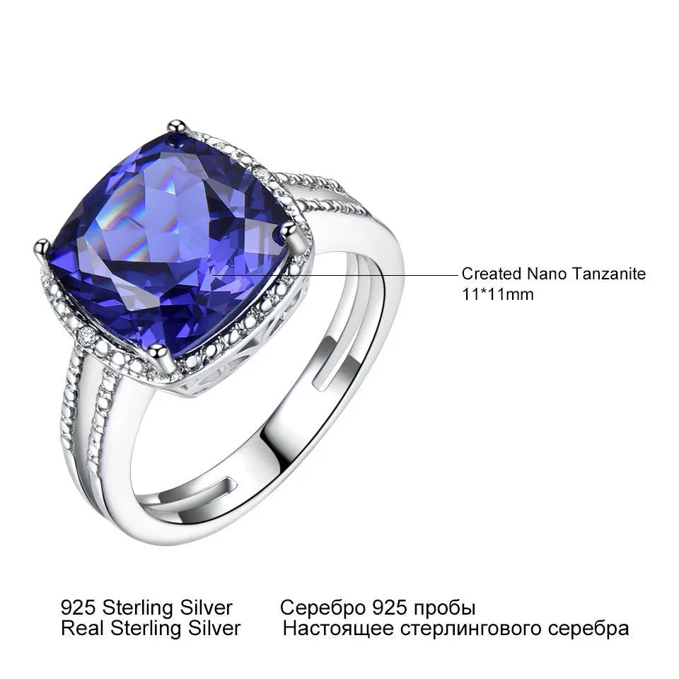 Women's sterling silver ring with a blue tanzanite gemstone on a polished band.
