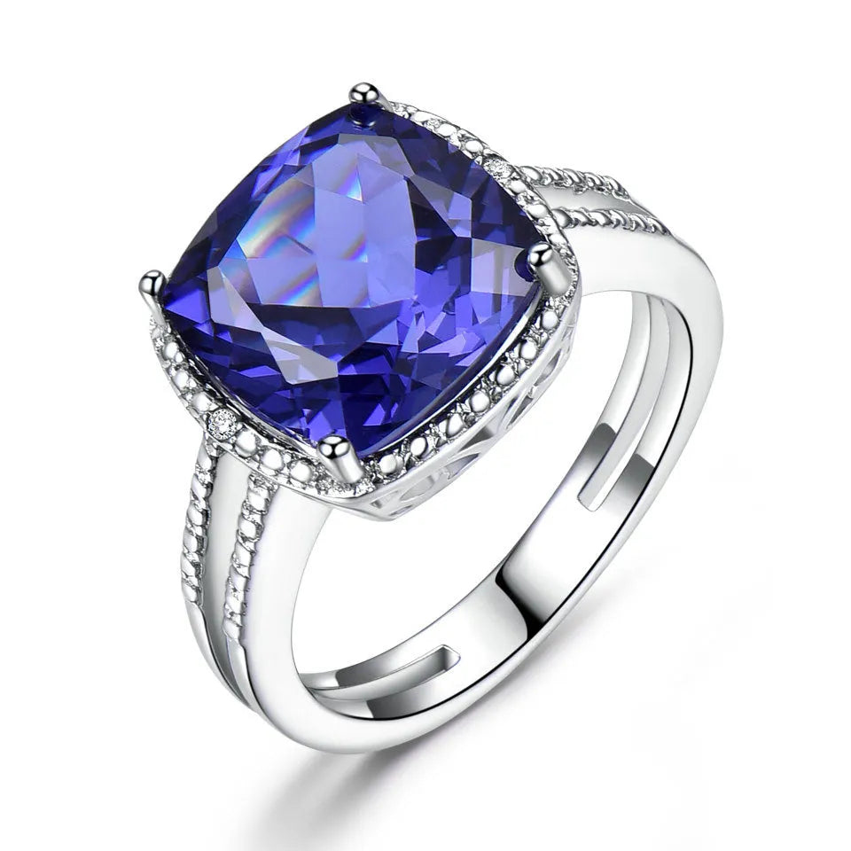 Women's sterling silver ring with a blue tanzanite gemstone on a polished band.