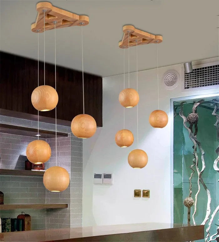 Nordic style solid wood ball chandelier with wooden spheres hanging from a wood disc ceiling plate.