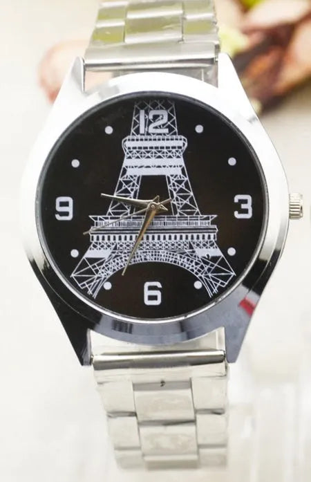 Silver Eiffel Tower engraved dial on a stainless steel wrist watch with a silver-toned strap.