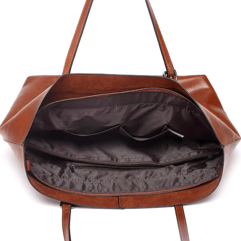 Brown waxed cowhide leather crossbody handbag showing two compartments and phone pocket