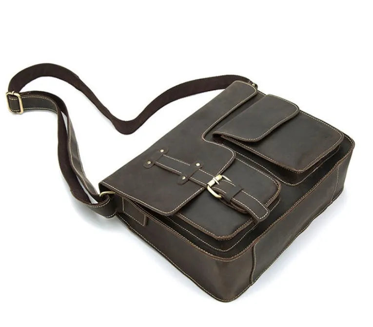 A leather vintage messenger crossbody bag shown in dark coffee colour with a flap closure and adjustable strap.