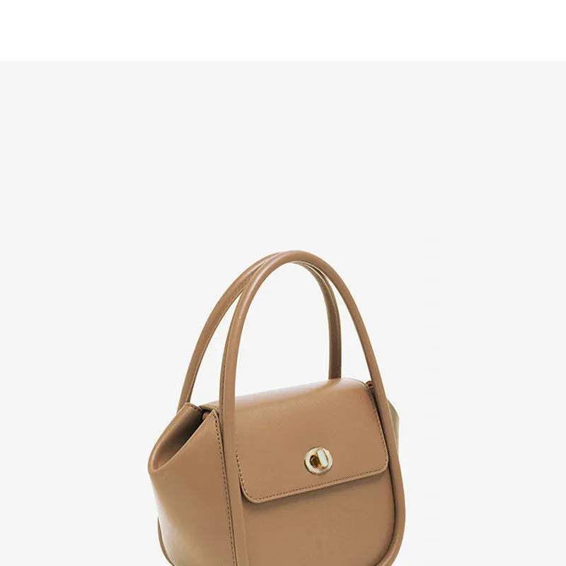 Leather wing bag with latch closure and buckle detailing in cow leather with cross-body strap