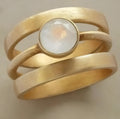 Gold-plated titanium steel ring with white chalcedony micro-inlay in geometric design
