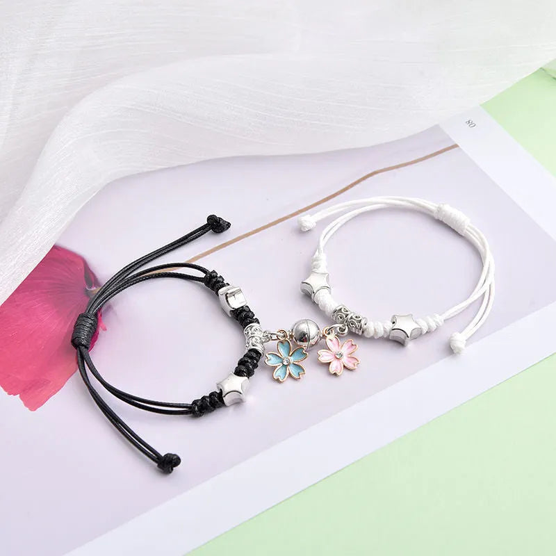 Magnetic couple bracelet pair with alloy electroplating in various designs including clover and crown patterns