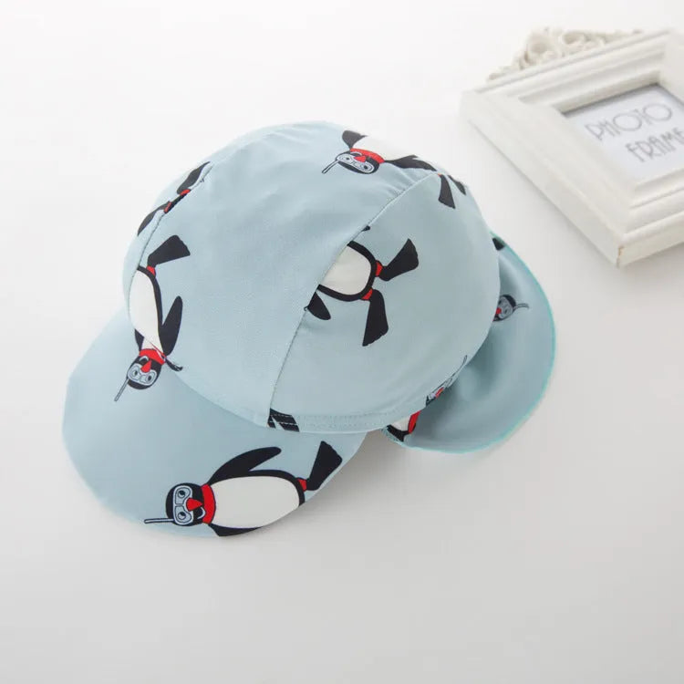 Boys' penguin print long sleeve one-piece swimsuit with matching swimming cap set.