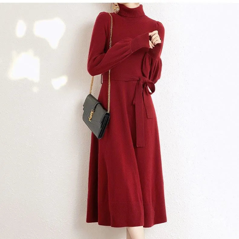 A rose red turtleneck knit dress with long sleeves, an elastic waist, and a loose mid-length skirt.