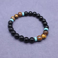Black geometric agate bracelet and necklace set on a display background.