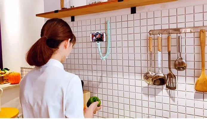 Black flexible worm arm phone holder with suction cup attached to a bicycle handlebar