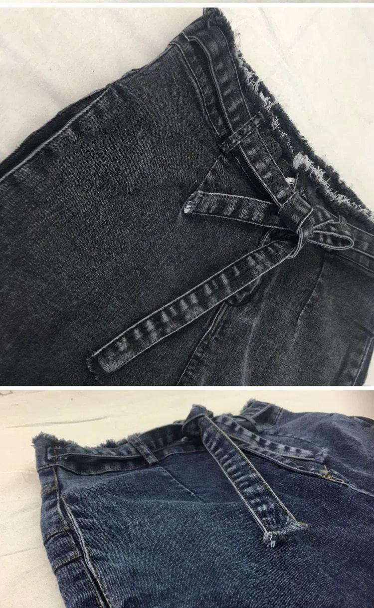 Women's fringed jeans in cowboy denim fabric showing decorative leg fringing detail