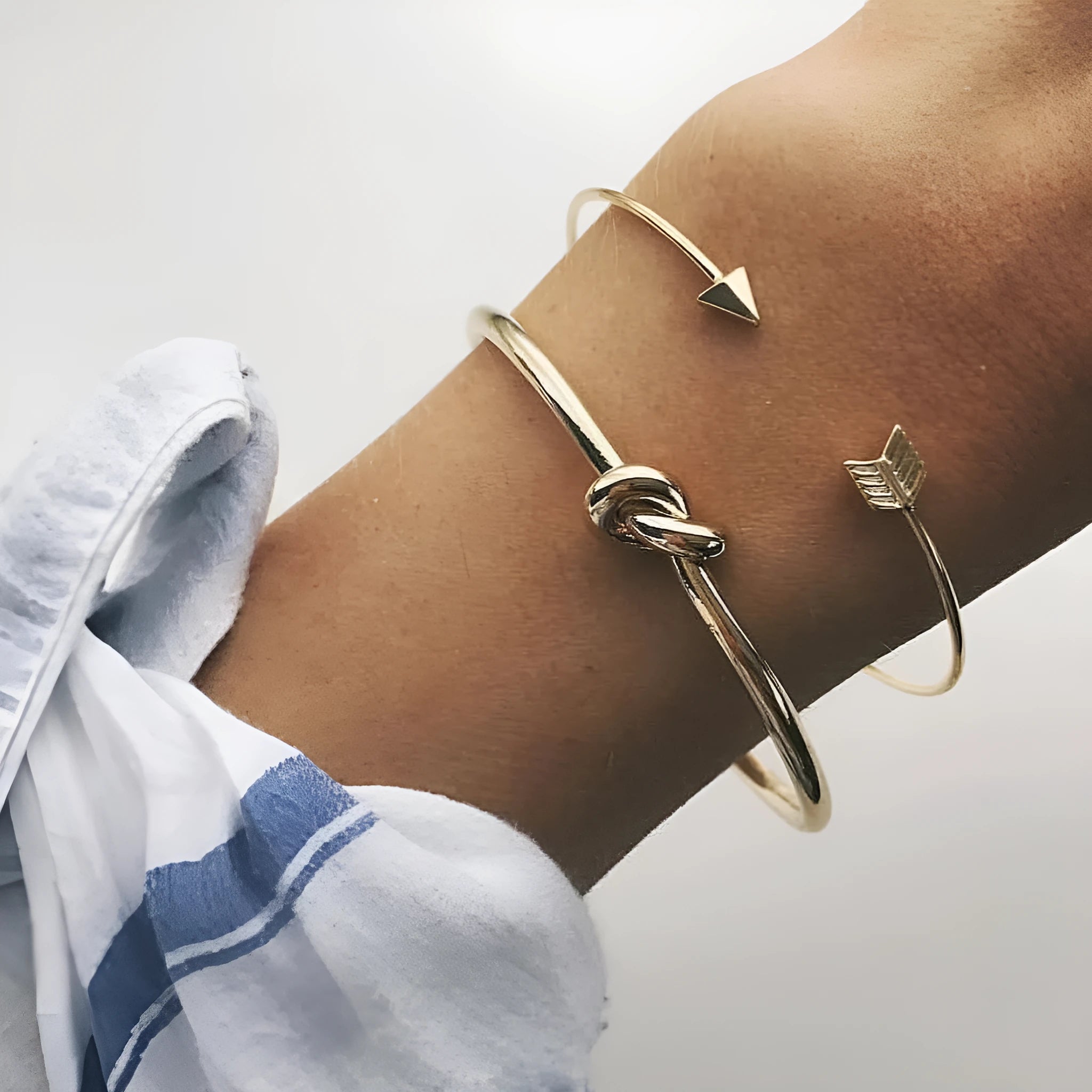 Women's vintage gold arrow knotted cuff bracelet made from electroplated alloy.