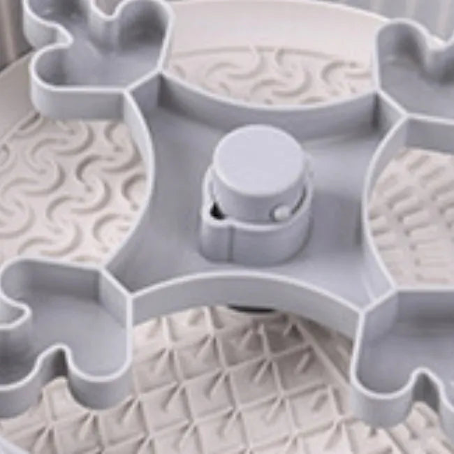 Grey plastic pet bowl with rotating windmill-pattern slow feeder licking mat inside
