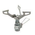 A portable single-burner propane camping stove with a one-piece metal furnace, shown outdoors.