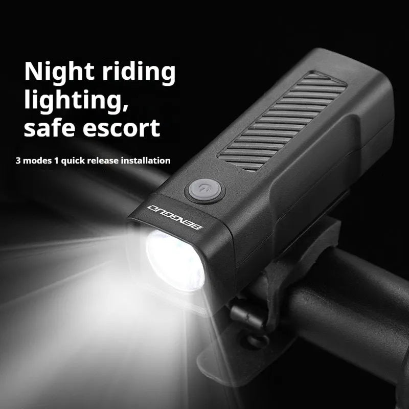 Black USB-rechargeable bicycle headlight with quick-release strap mount on handlebars.
