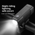 Black USB-rechargeable bicycle headlight with quick-release strap mount on handlebars.